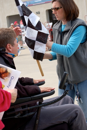 Photo by Christine Allen.  I was touched by his dedication to his fans, who are just as dedicated to him.  He later signed a smaller flag for my daughter on community day.